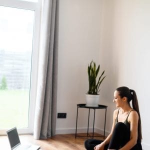 Online Yoga for beginners and all levels, a yoga practitioner with a laptop . Yoga at home concept