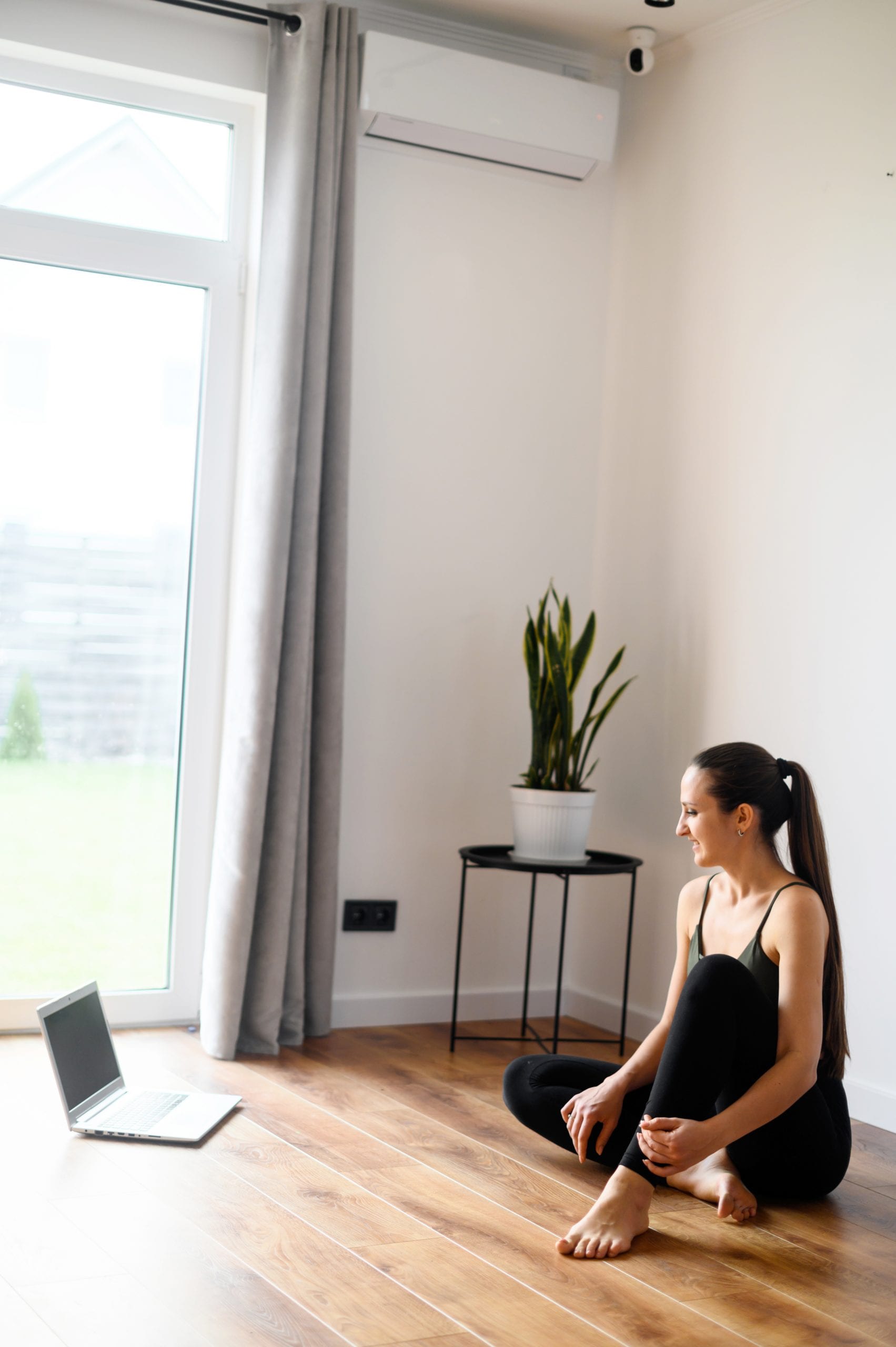 Online Yoga for beginners and all levels, a yoga practitioner with a laptop . Yoga at home concept