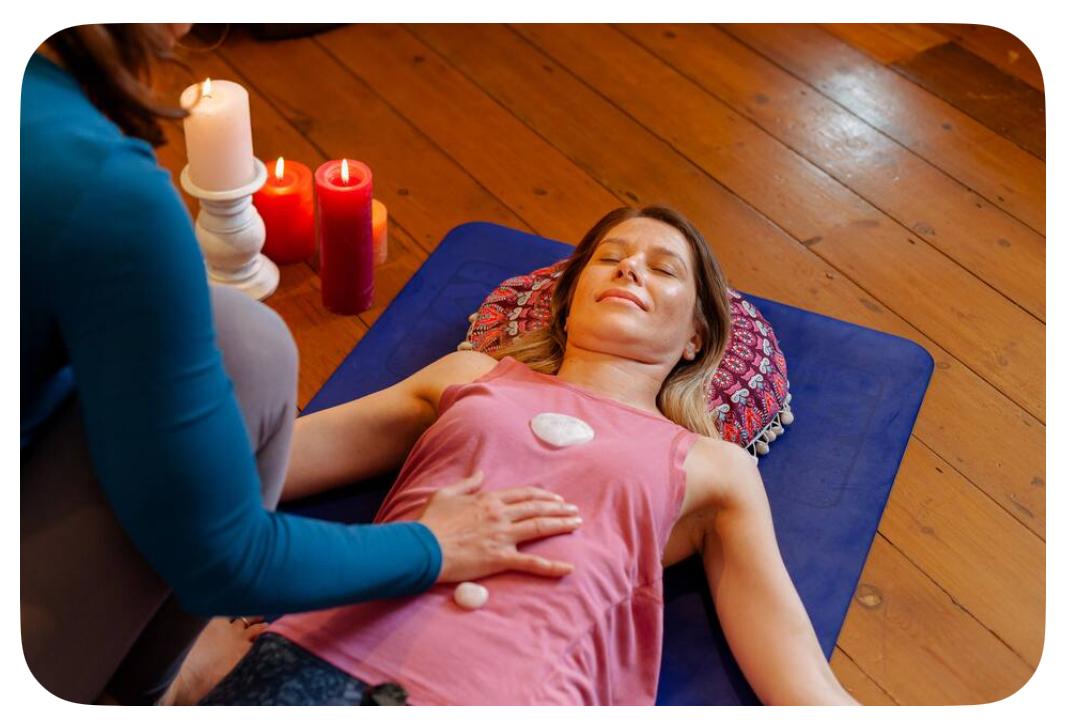 Hands on body during a Reiki healing session, supporting relaxation and energy flow.