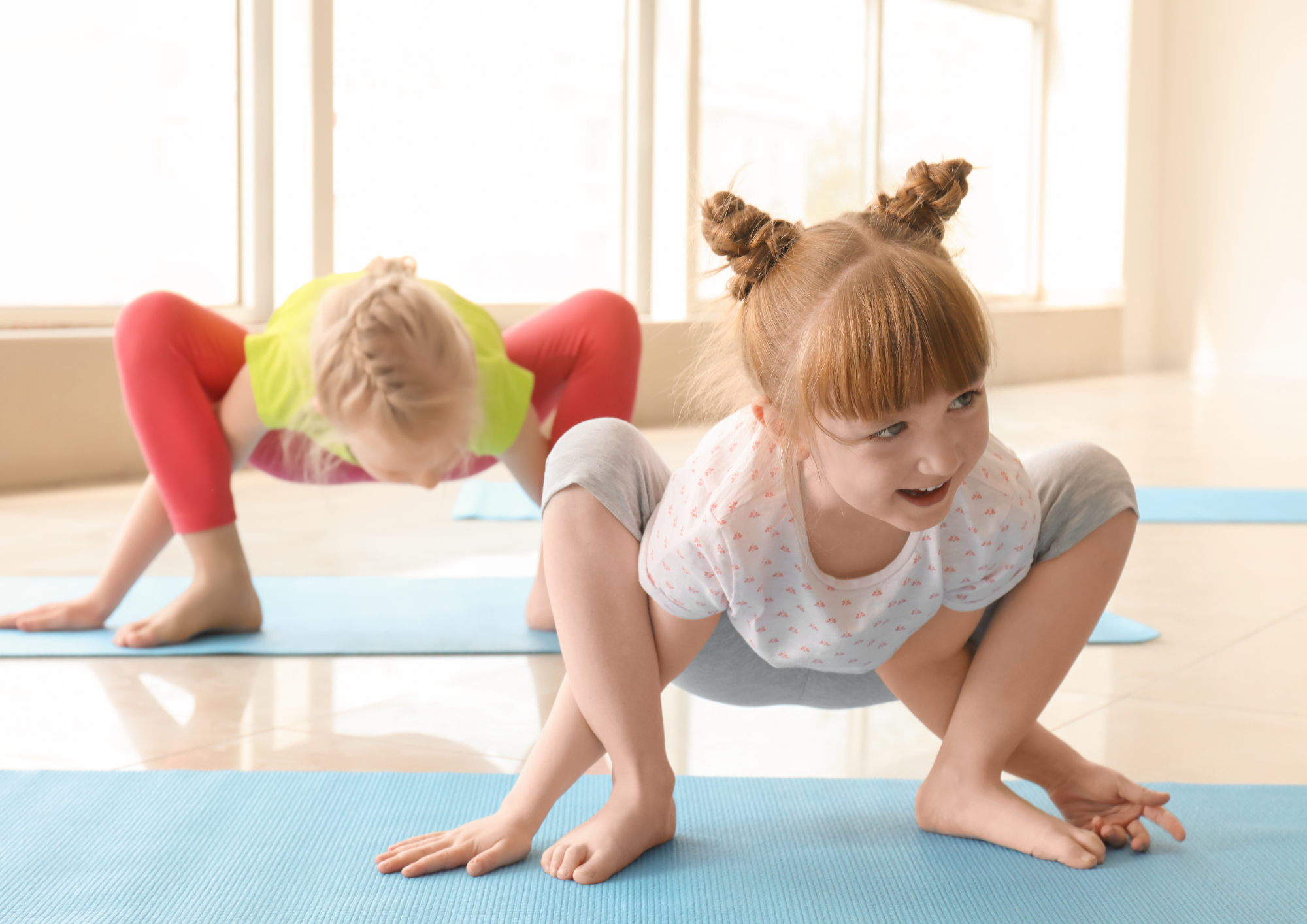 A group of children practicing yoga together in a fun and playful way, smiling and moving freely, creating a joyful and engaging atmosphere for a family celebration.