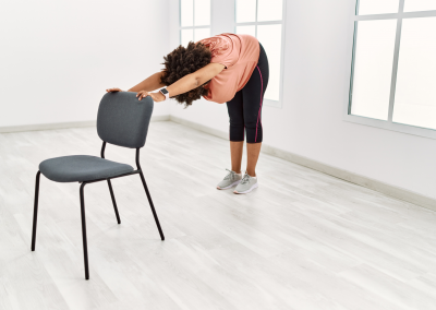 An upper body stretch using the back of a chair relieving tension in back and shoulders