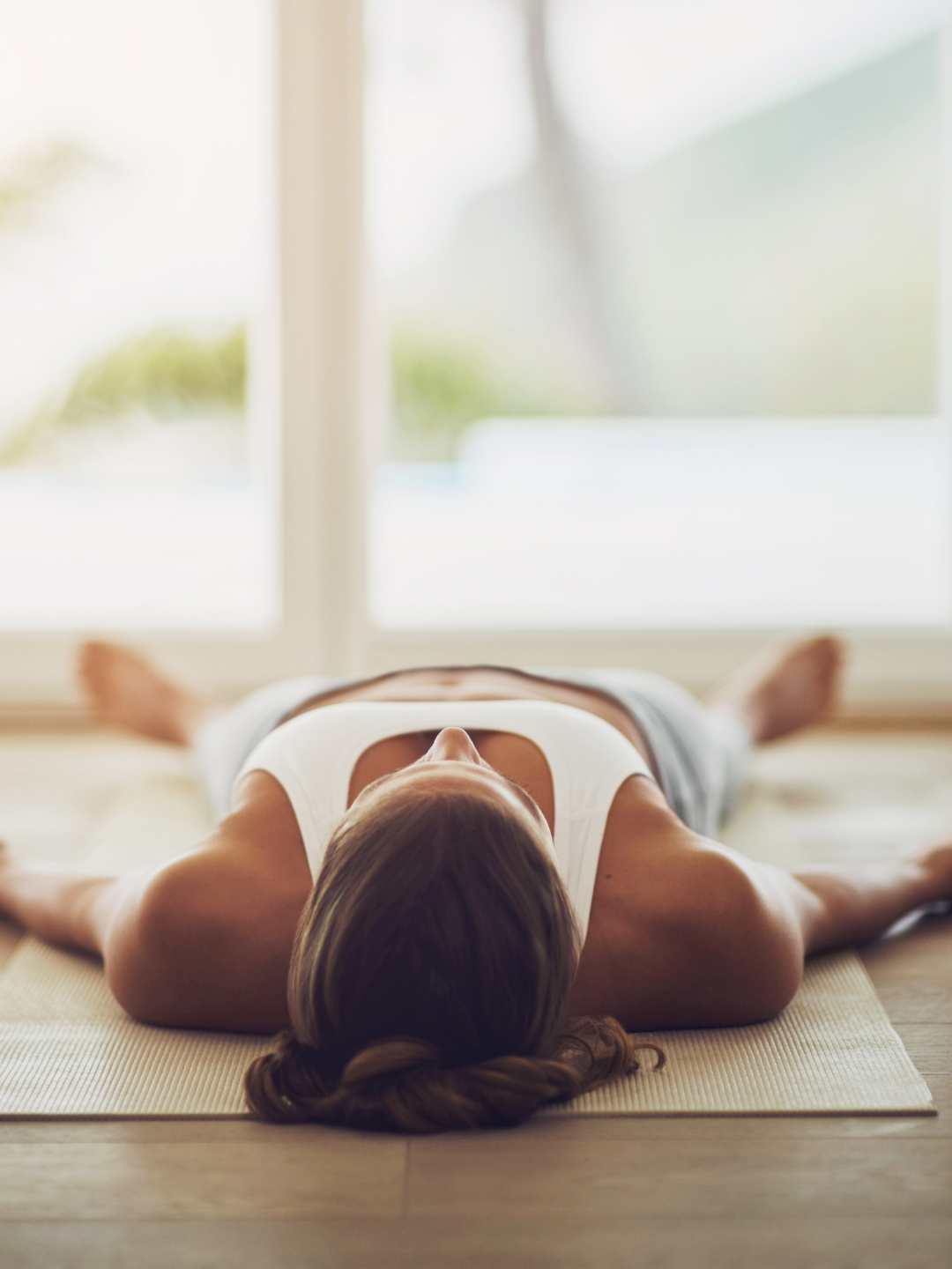 A person lying down with eyes closed receiving Reiki, in a state of deep relaxation.