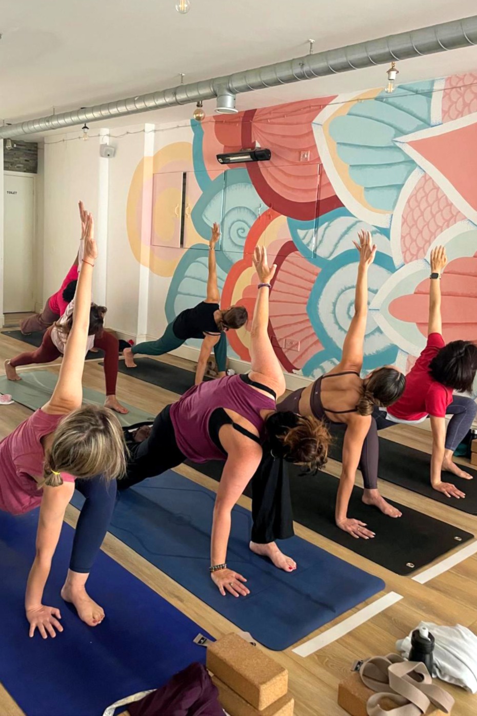 A group of people practicing yoga in a studio