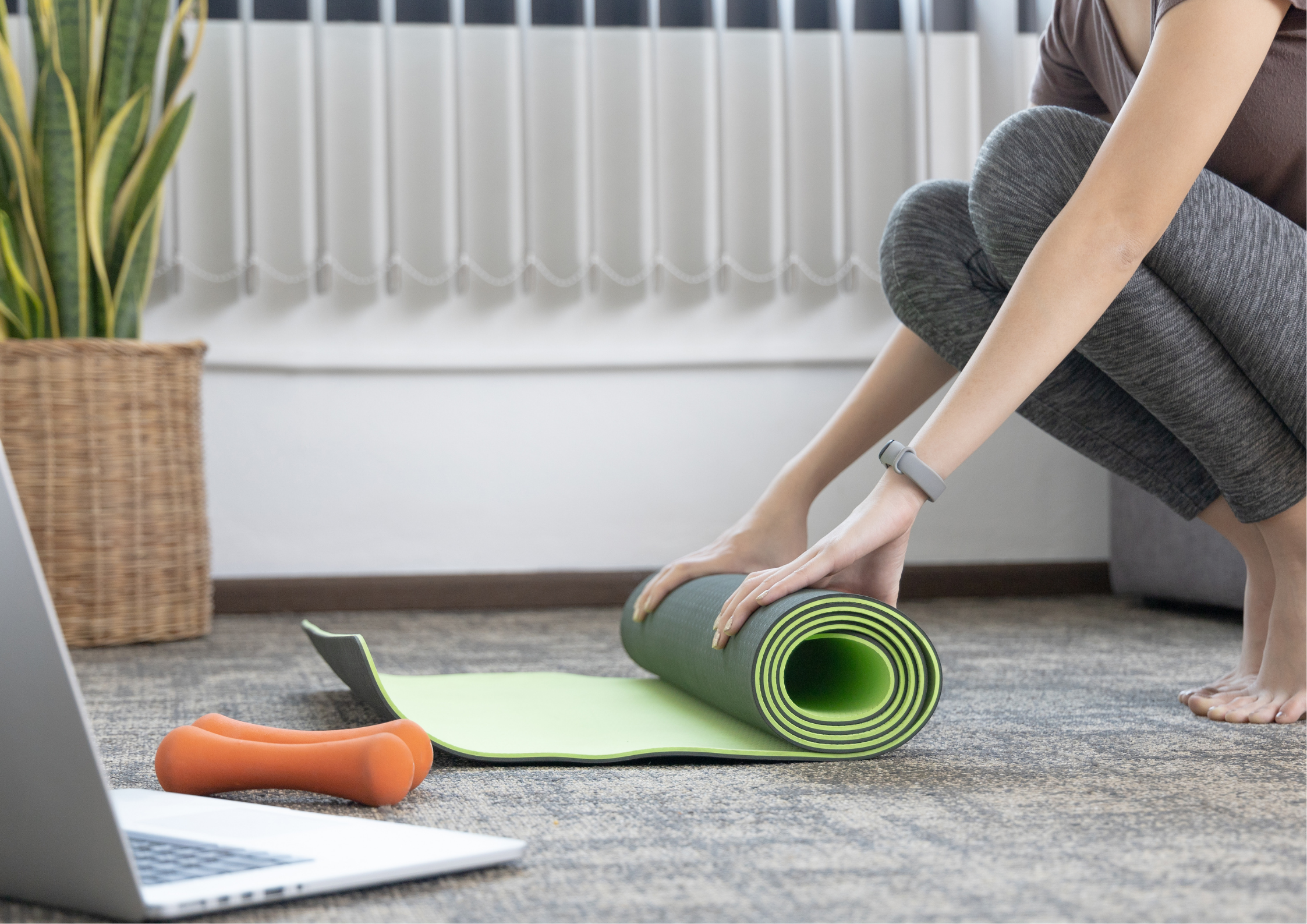 Yoga mat and laptop prepared for an online yoga session at home.